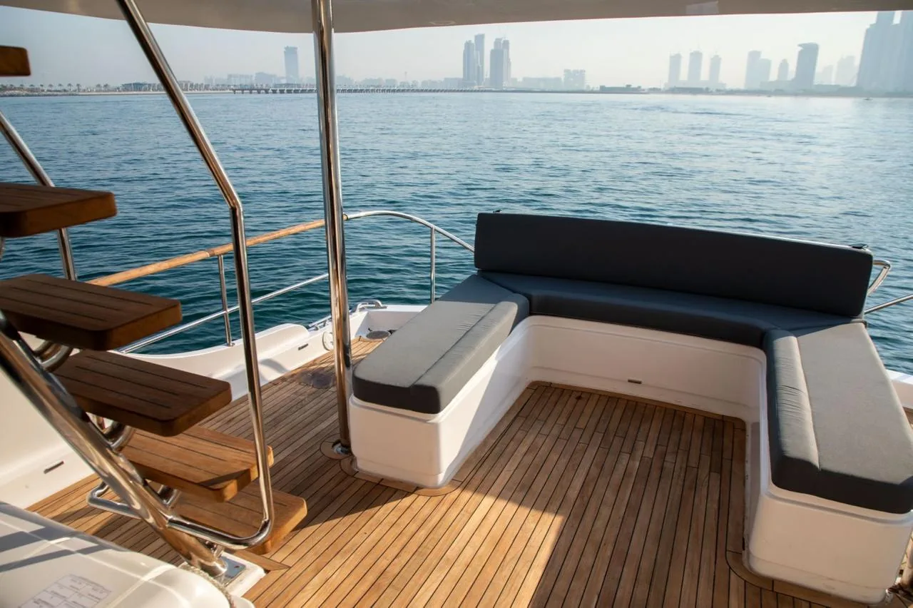 Teak aft deck seating overlooking the Dubai skyline