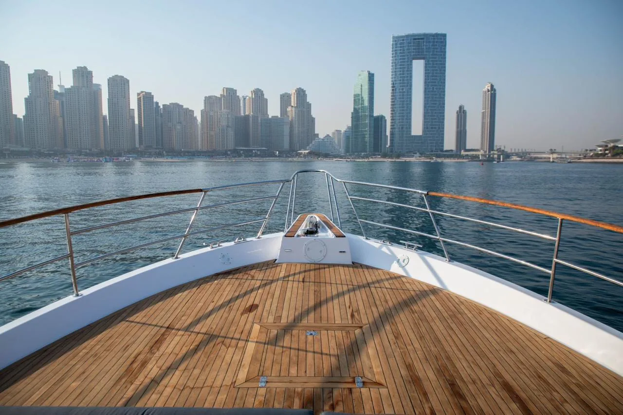 View forward over the teak bow toward Dubai Marina